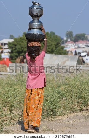 stock-photo-pushkar-india-november-an-unidentified-girl-carrying-a-pots-on-her-head-attends-the-240572692